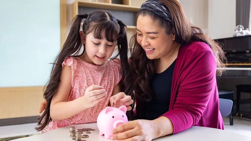 mother_teaching_her_daughter_to_save_money.webp